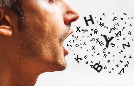 This image shows a side profile image of a man talking and the alphabet coming out of his mouth.