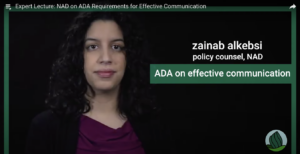 A video screenshot of a long black haired person in a purple blouse and black blazer jacket with the text, "Zainab alkebsi, policy counsel, NAD ADA on effective communication"