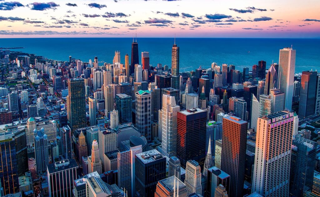 This is a rectangular image. This image is taken from an Aerial view of a city with big skyscrapers.