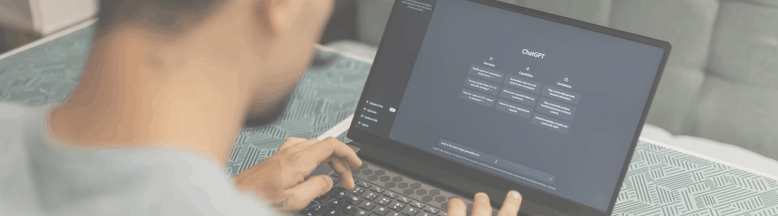 Photo of a person using a laptop for ChatGPT.