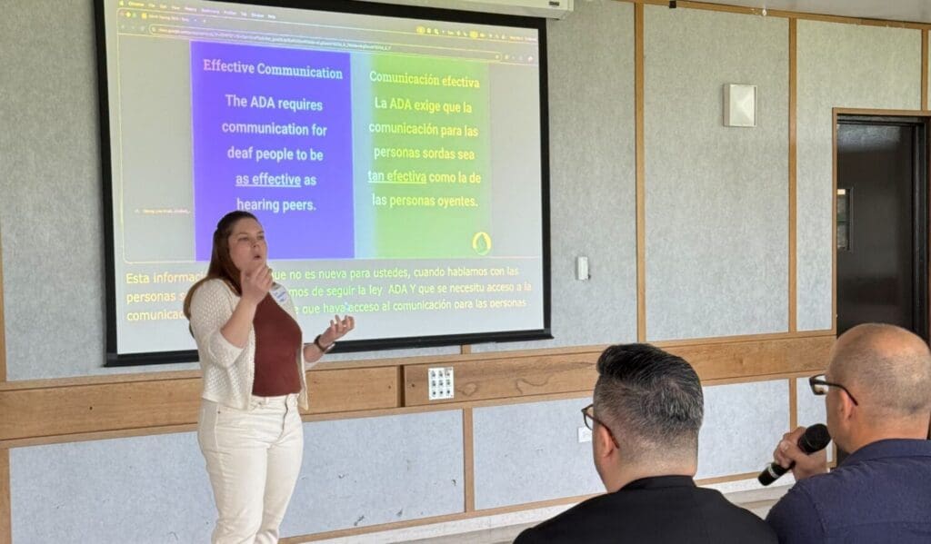 Woman giving a presentation on effective communication for deaf people.